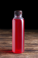 Small bottle of cranberry juice. Natural fruit-drink.