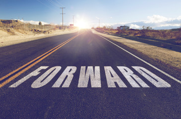 new beginnings, travel and adventure concept - close up of word forward on suburban asphalt road