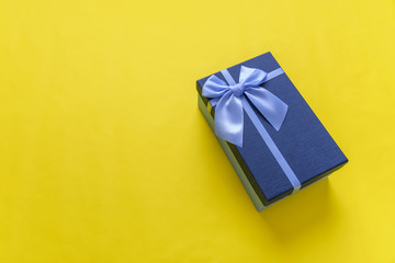 Gift box on a yellow background. Close-up.