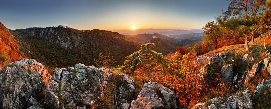 Mountain autumn landscape with colorful forest and Uhrovec castle, Slovakia