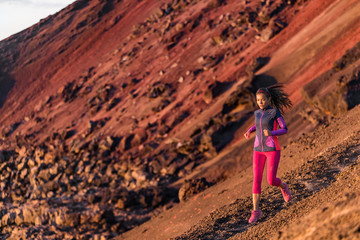 Runner athlete running on mountain trail. Young woman ultra run athlete running fitness workout....