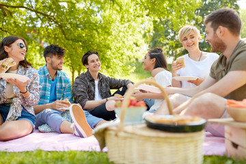friendship, leisure and fast food concept - group of happy friends eating sandwiches or burgers at...