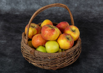 basket with red and yellow apples