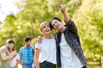 Fototapeta premium people and relationships concept - happy teenage couple hugging at summer park