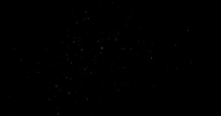 Flying dust particles on a black background
