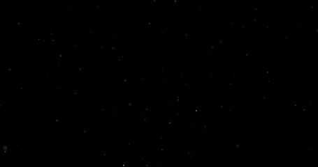 Flying dust particles on a black background
