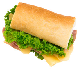 Fresh baguette sandwich with ham, cheese, tomatoes, and lettuce isolated on white background.
