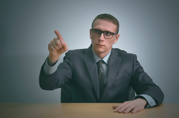 Businessman is pointing by his index finger on a copy space invisible virtual buttons.
