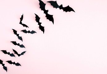 Halloween decorations concept. Halloween bats on pastel pink background. Flat lay, top view, copy space 