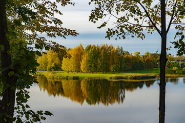Fototapeta na wymiar Tranquil autumn lake with colorful reflections