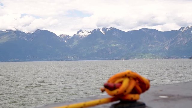 A view of the Sunshine Coast as seen from the deck of a ferry with a rope cleat in the foreground.