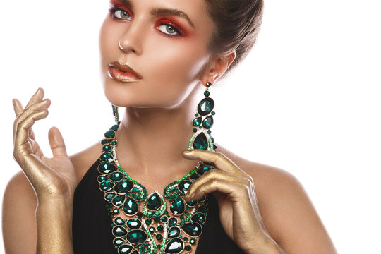 Sexy woman wearing big beautiful necklace and earrings with a lot of gems