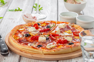 Pizza with Mozzarella, Ham, Cherry Tomatoes, Black Olives