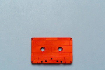 Obraz premium One single retro audio cassette on light grey background, top view