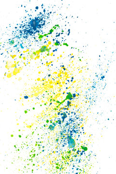 Watercolor paint sprinkles splatter of green, blue and yellow paint on white paper