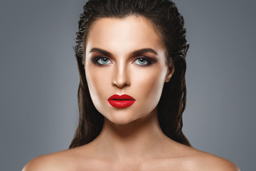Portrait of beautiful young woman with a red lipstick