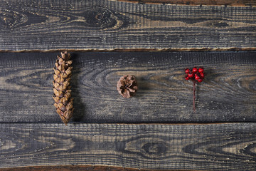 Top view, flat lay. Christmas composition made of big cones on wooden background