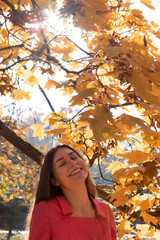 Portrait of beautiful, dreamy girl with long brunette hair in autumn park.