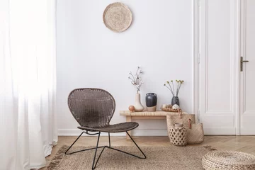 Foto op Plexiglas Dark, modern wicker chair in a white living room interior with a wooden bench and decorations made from natural materials © Photographee.eu