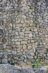 Fragment of the stone wall of the ancient city. Russia, the Republic of Crimea, the city of Sevastopol. 11.06.2018: The ruins of the ancient and medieval city of Chersonese Tauride