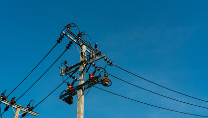 High voltage electric pole and transmission lines with clear blue sky. Electricity pylons. Power...