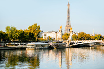 Alexandre bridge and Eiffel tower on Seine river during the morning light in Paris