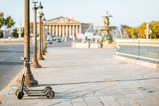 Electric scooters on the street near Concordia square during the morning light in Paris