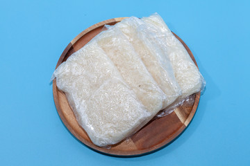 close up of sticky rice in plastic bag in Thai style on blue background