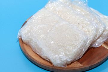 close up of sticky rice in plastic bag in Thai style on blue background