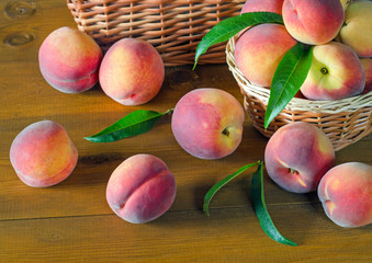 Ripe peaches on a wooden table. © eladstudio