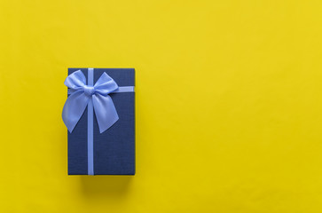 Gift box on a yellow background. Close-up.