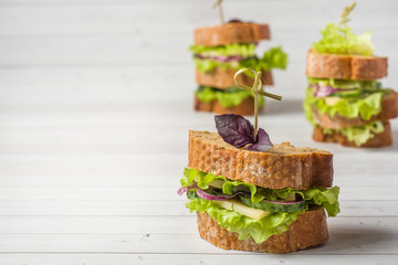 Sandwiches with cheese, cucumbers and onions with wheat bread. Selective focus. Copy space