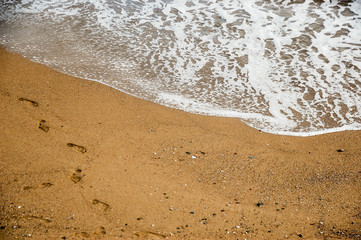 Fototapeta na wymiar Soft wave of blue ocean on sandy beach