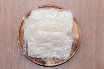 close up of sticky rice in wooden plate