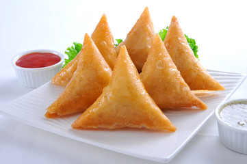 Samosa, Sambusa, Samboksa with a   savory filling of chicken, mince, potato & vegetables