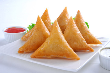 Samosa, Sambusa, Samboksa with a   savory filling of chicken, mince, potato & vegetables