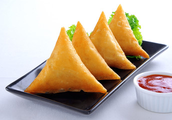 Samosa, Sambusa, Samboksa with a   savory filling of chicken, mince, potato & vegetables