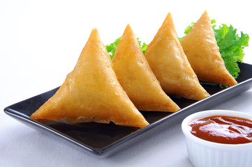 Samosa, Sambusa, Samboksa with a   savory filling of chicken, mince, potato & vegetables