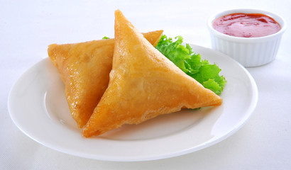 Samosa, Sambusa, Samboksa with a   savory filling of chicken, mince, potato & vegetables
