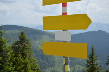 Empty signs with mountain scenery in the background