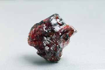 Uncut and rough deep red rhodolite garnet gemstone.