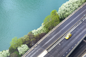 Road, yellow taxi and the Chicago River.