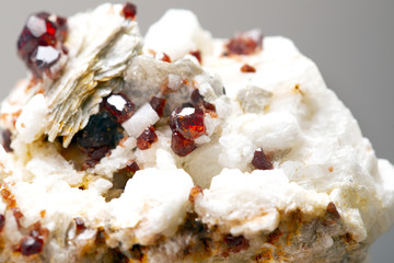 Uncut and rough deep red rhodolite garnet gemstone.