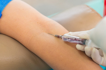 Nurse collecting a blood from patient in hospital
