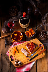 spicy roasted meat with mushroom sauce in the oven