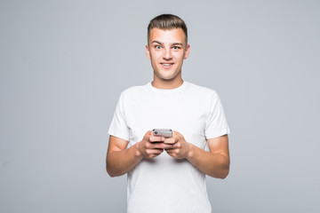 Happy man read sms on phone on gray background