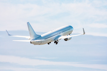 White passenger jet plane in the air on take-off