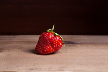 Strawberry fresh ripe sweet berry on wooden background.