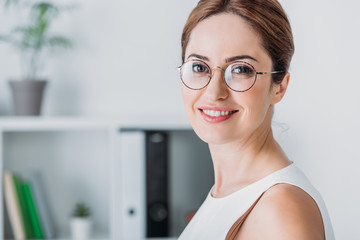 portrait  of attractive smiling businesswoman in eyeglasses