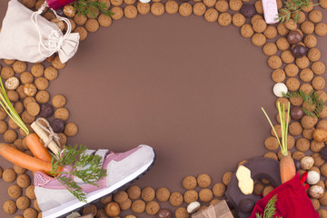 Dutch holiday Sinterklaas background with pepernoten.Traditional sweets and gifts for children for the holiday. Free space for text. Top view. Copy space. Boot, carrot and letter with desires.